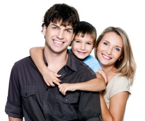 a family of three poses and smiles